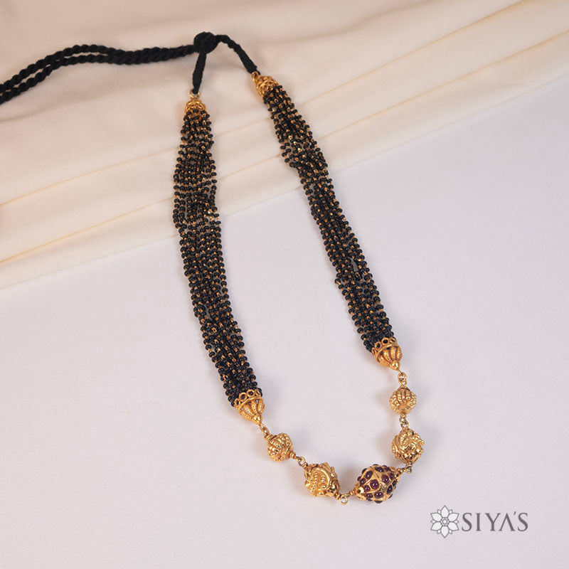 Black beads with gold gundu chain