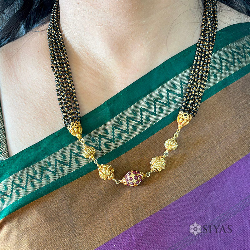 Black beads with gold gundu chain