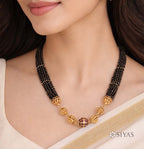 Black beads with gold gundu chain