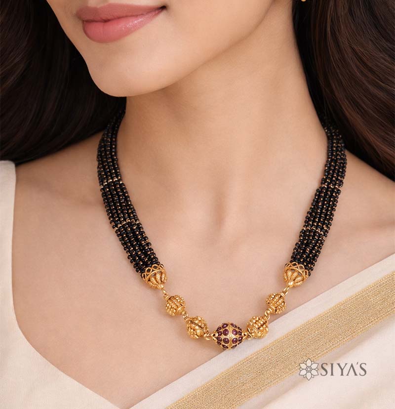 Black beads with gold gundu chain