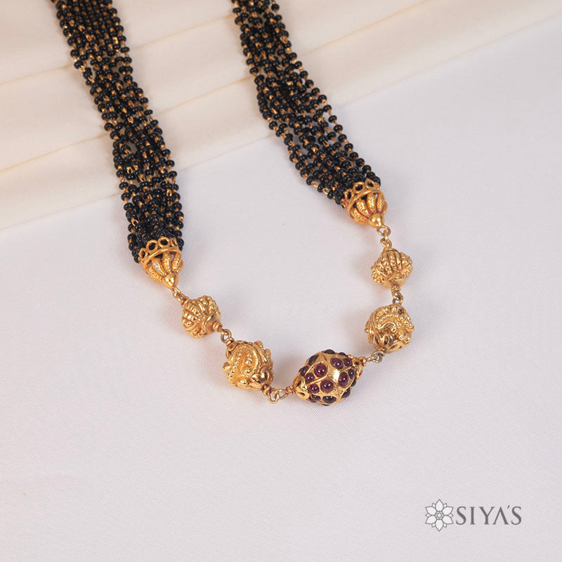 Black beads with gold gundu chain
