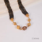 Black beads with gold gundu chain
