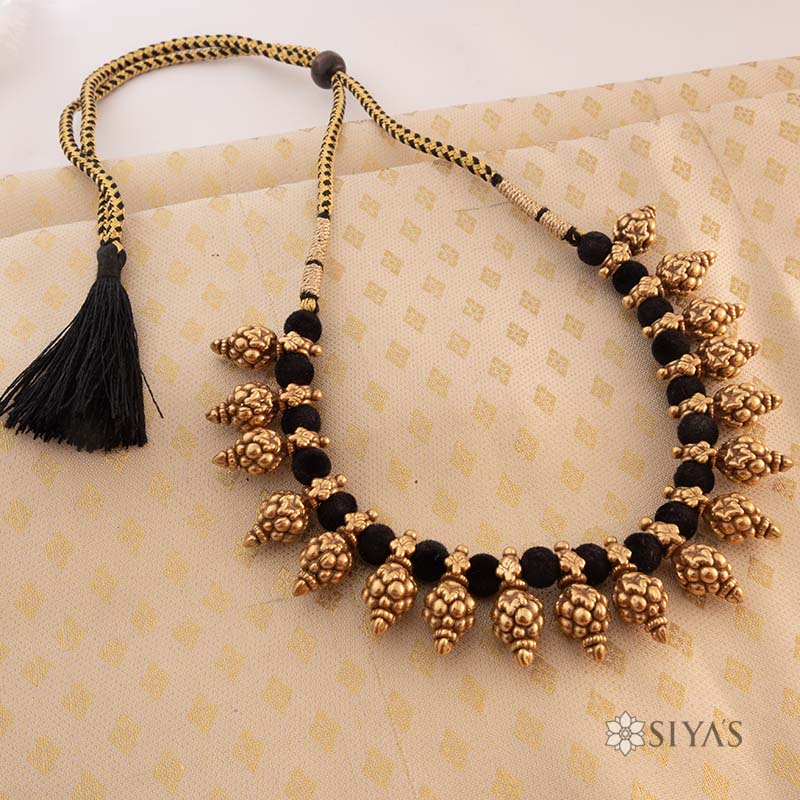 Black thread with gold motifs