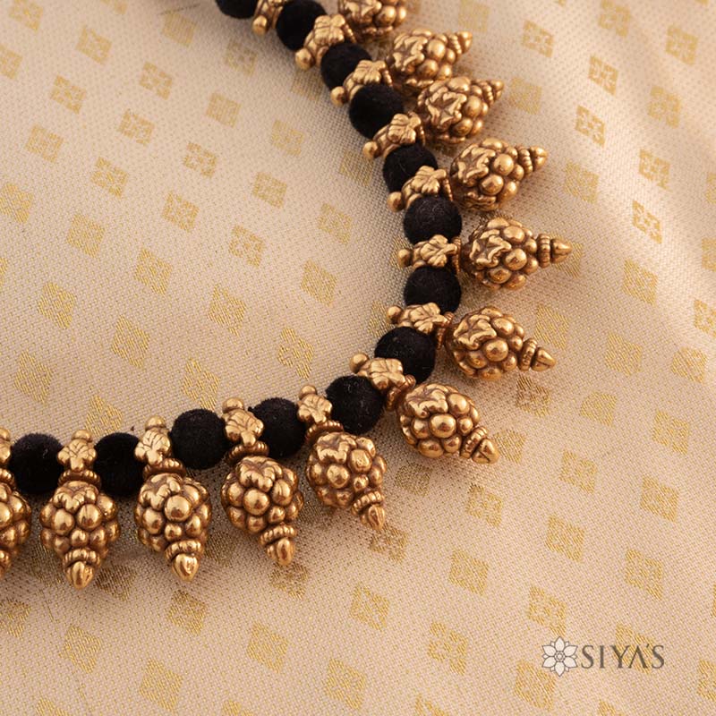 Black thread with gold motifs