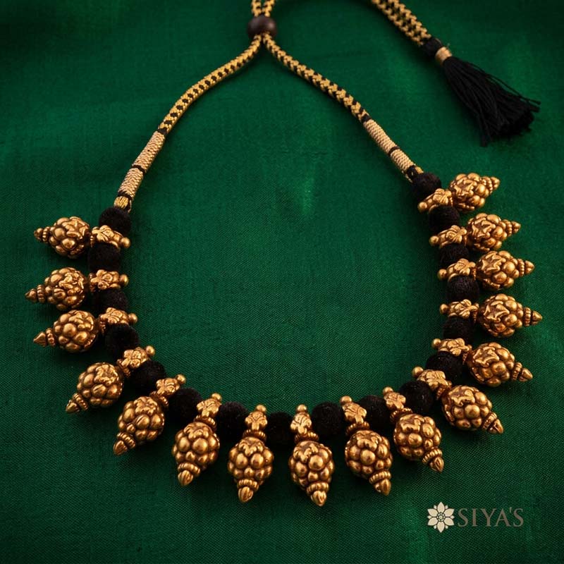 Black thread with gold motifs
