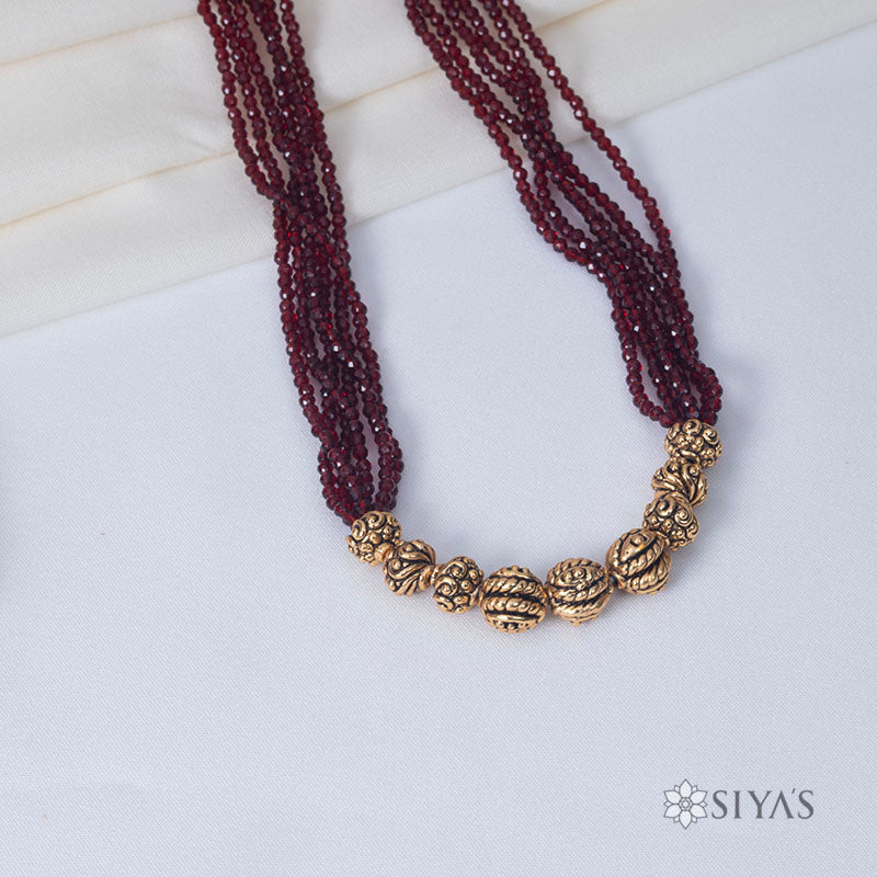 Red beads with small gold gundus