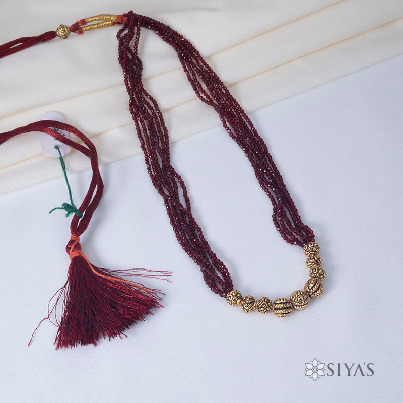 Red beads with small gold gundus