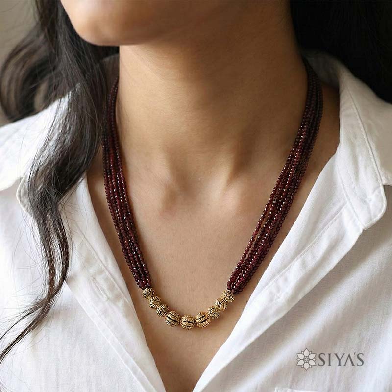 Red beads with small gold gundus