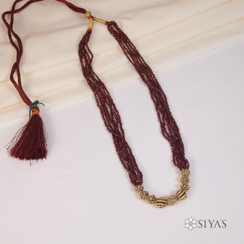 Red beads with small gold gundus
